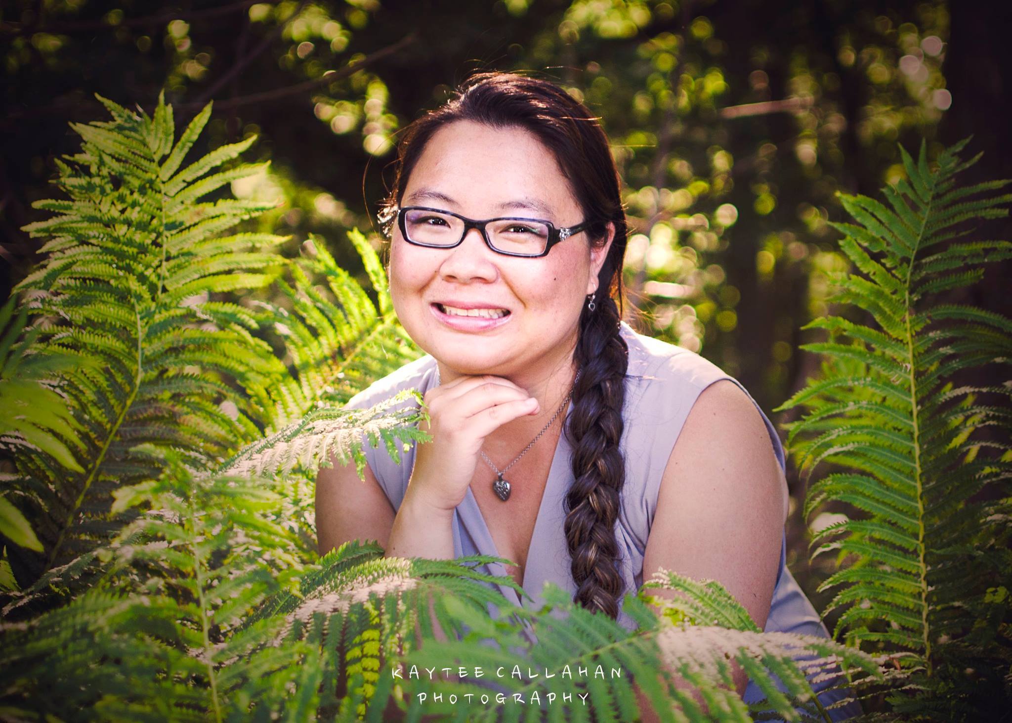 Portrait of Mai Chao Duddeck seated among ferns