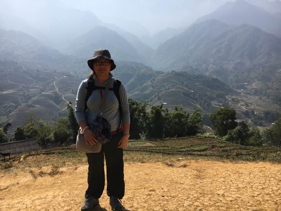 Mai Chao Duddeck standing in front of the mountains in Vietnam