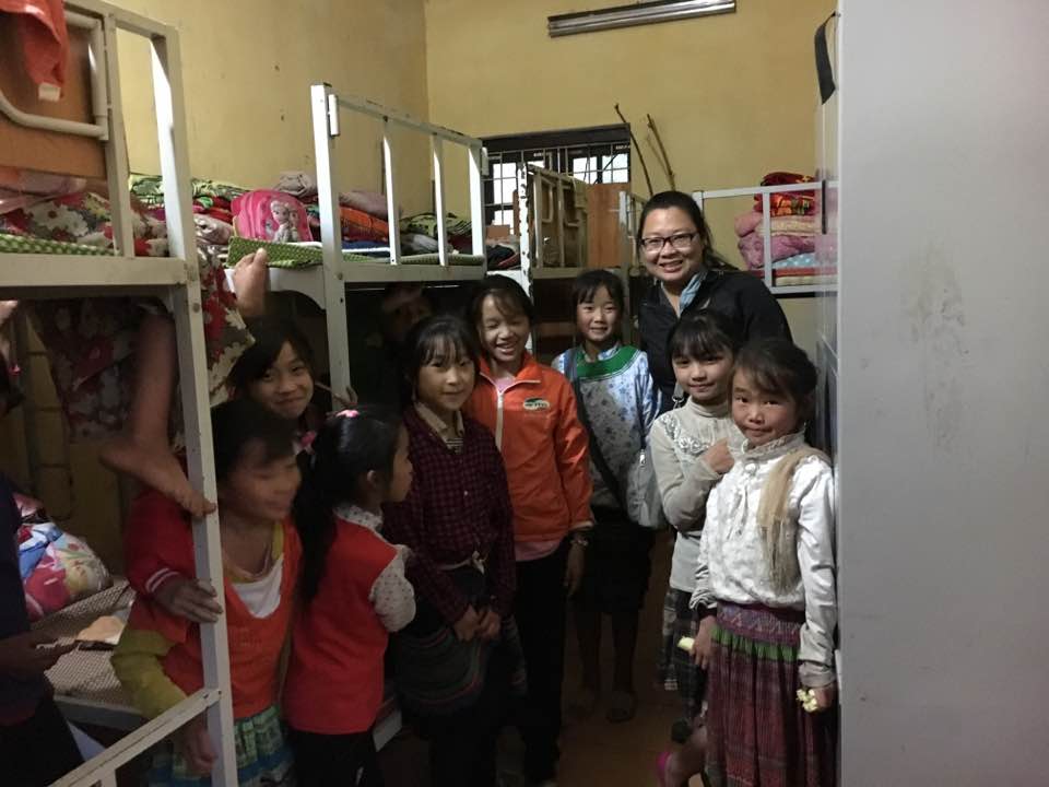 Mai Chao Duddeck poses with a group of schoolgirls from Sapa, Vietnam