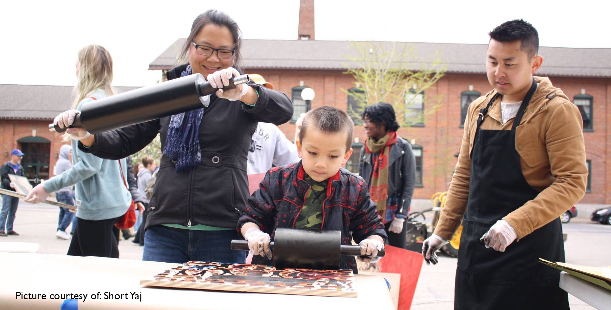 Mai Chao Duddeck and her son, Ari, happily prepare woodcuts for print.