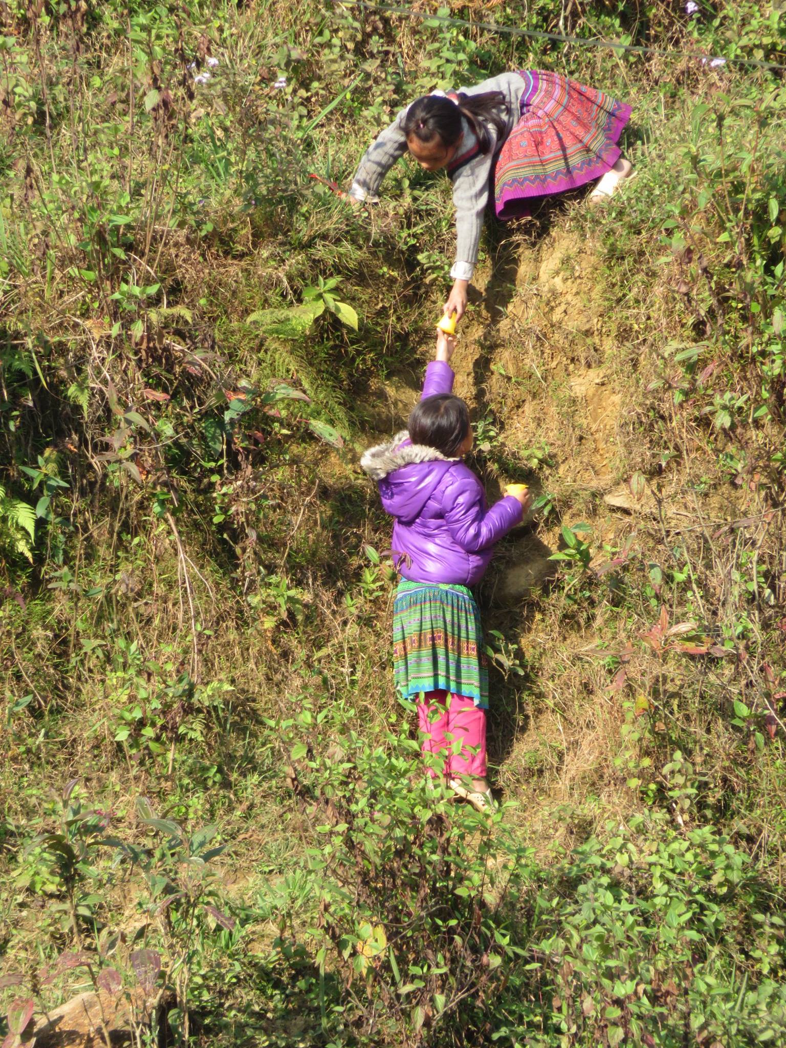 One girl handing off an item to another girl